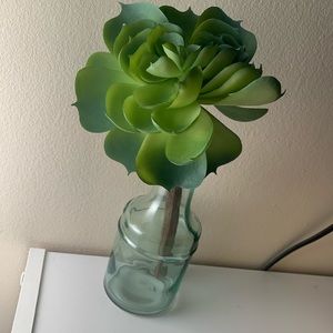 Fake flower in little glass container